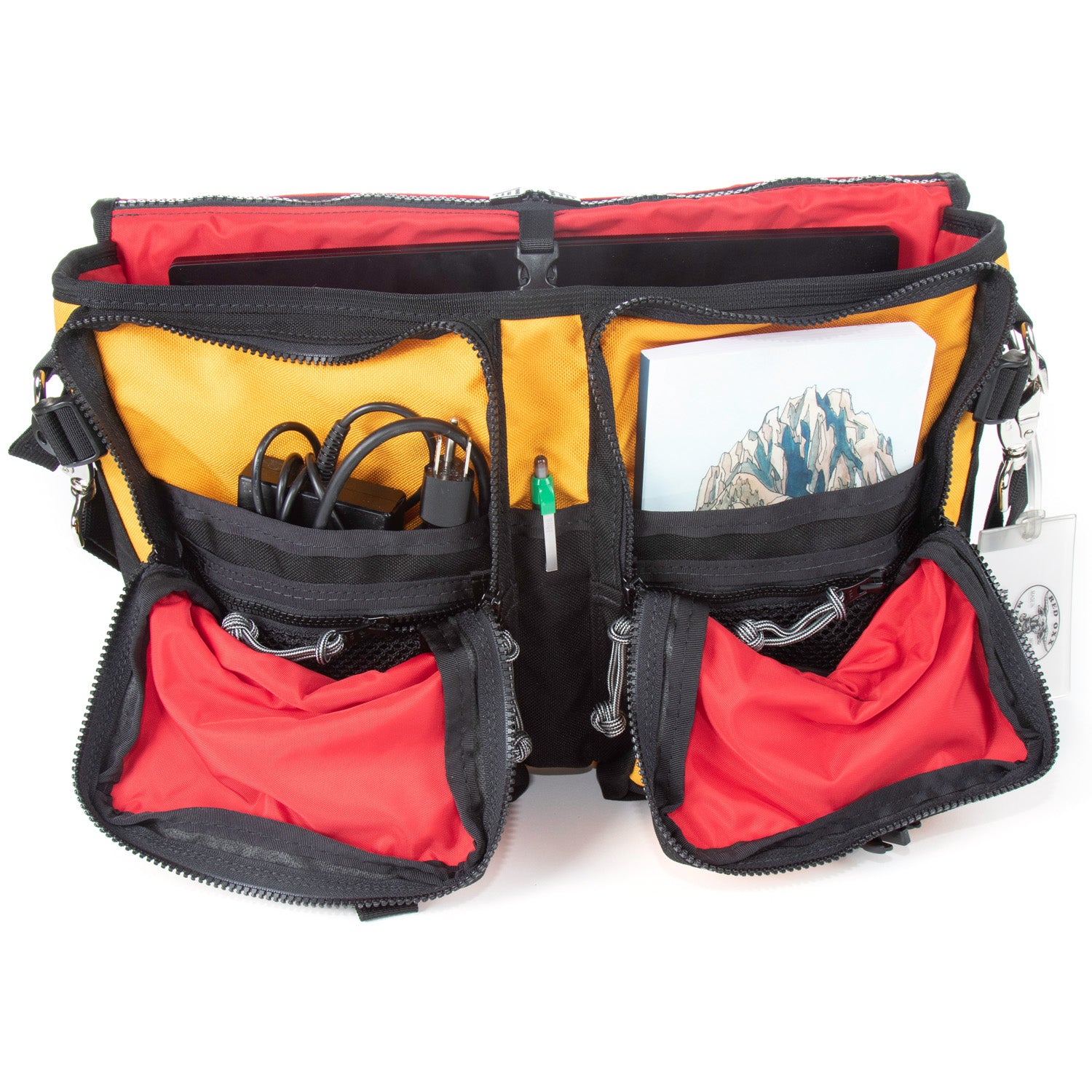 Fully open view of interior pockets and storage options.  Note the Fastex buckle for securing laptop or tablet. 