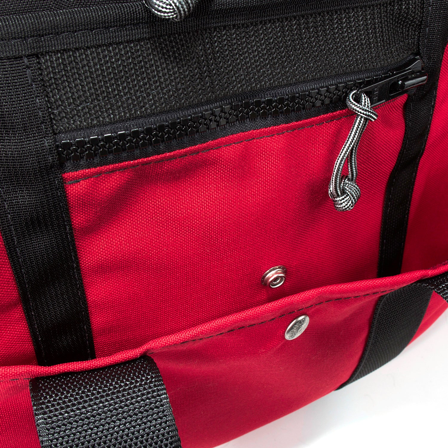 Stainless steel snap closure on outside of bag. Smaller zippered pocket for passport and plane ticket.