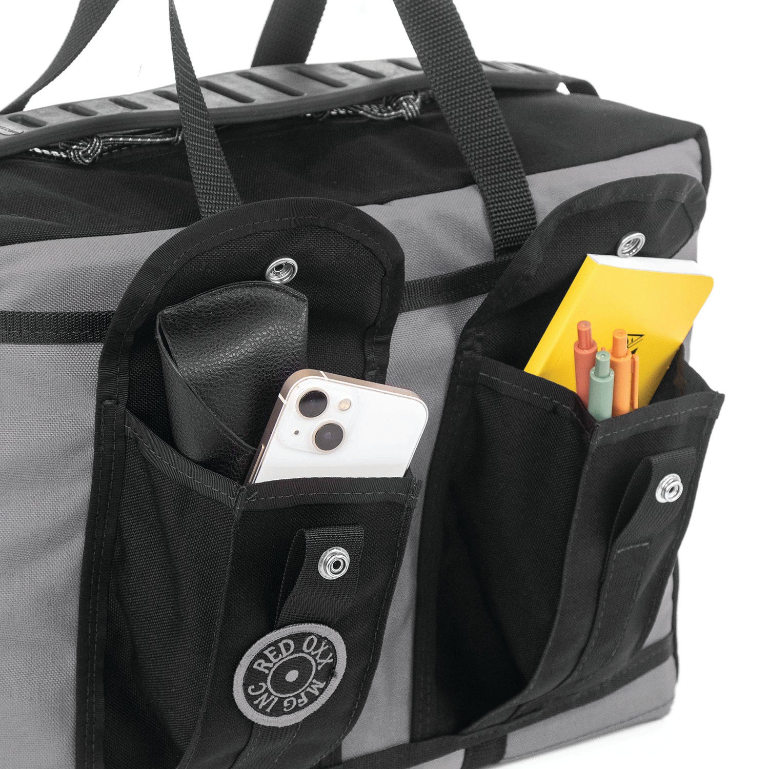 Closeup view of raised side pockets with sun glass case, smart phone easily fits. Write in the rain note book and pens are not included.