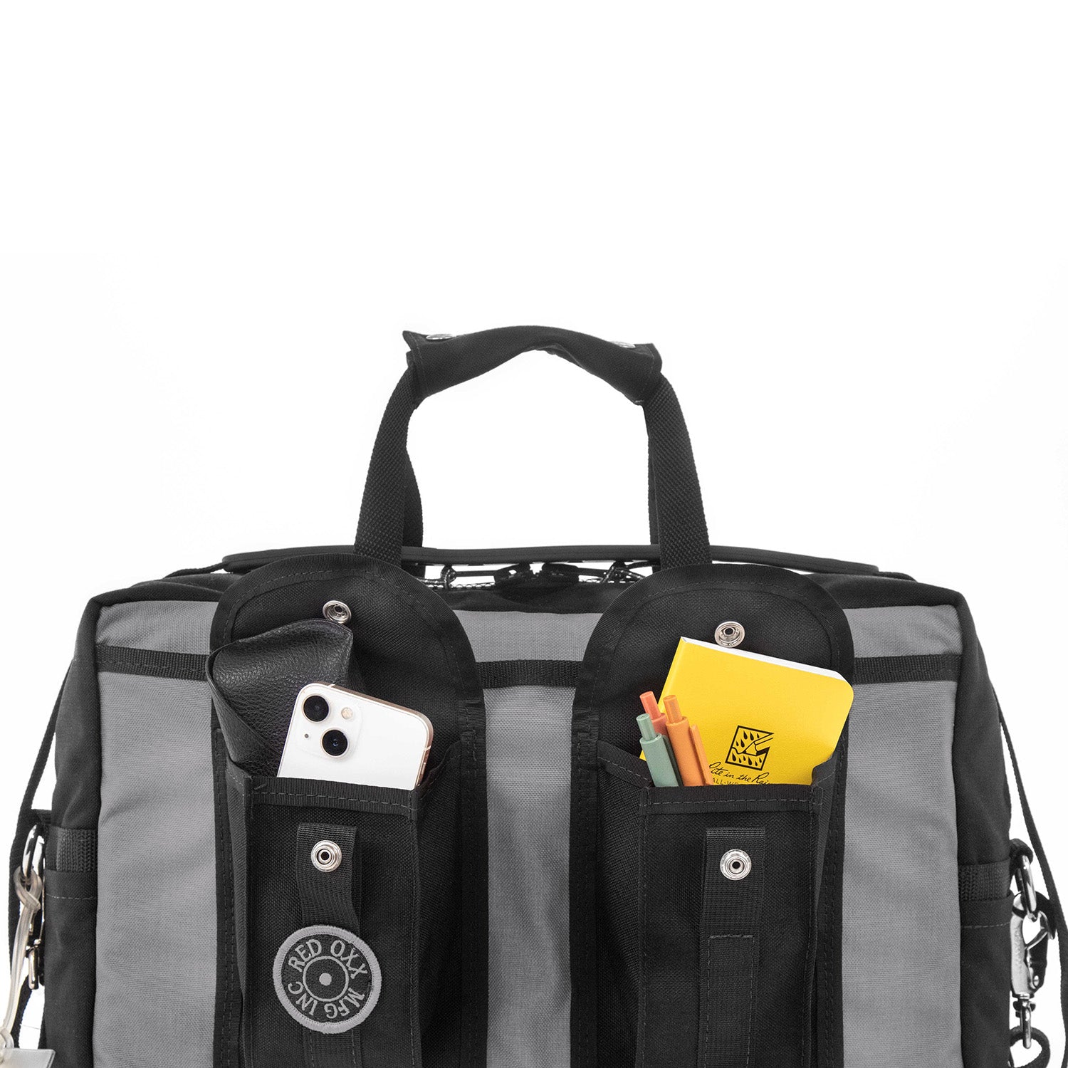 Raised pockets fit smart phone and notebook.