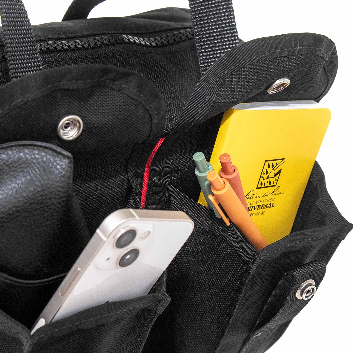 Close up view of the expandable side pockets with EDC gear. 