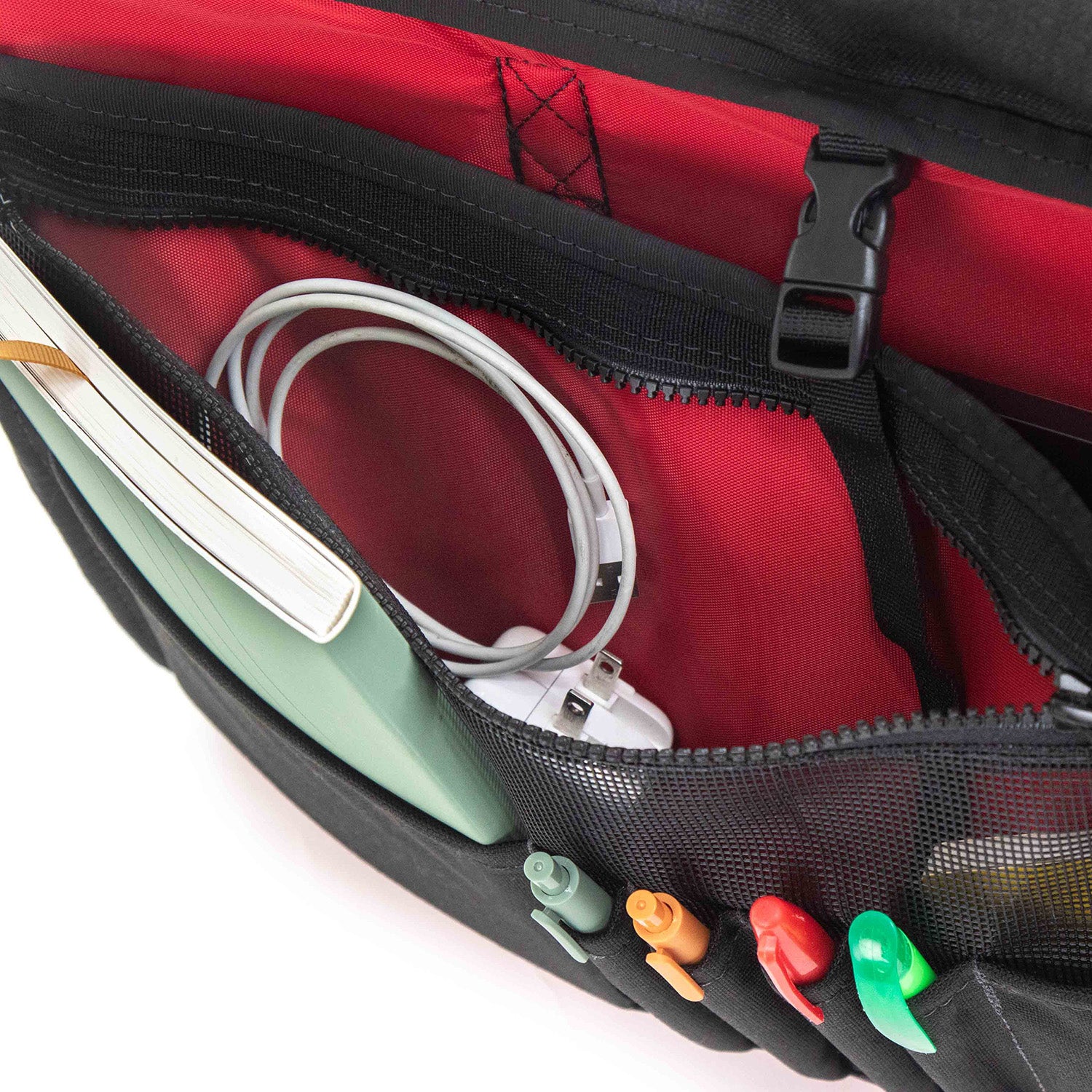 Interior red lining and mesh pocket with zippered closure. Pen and pencil slots and pocket for small notebook.