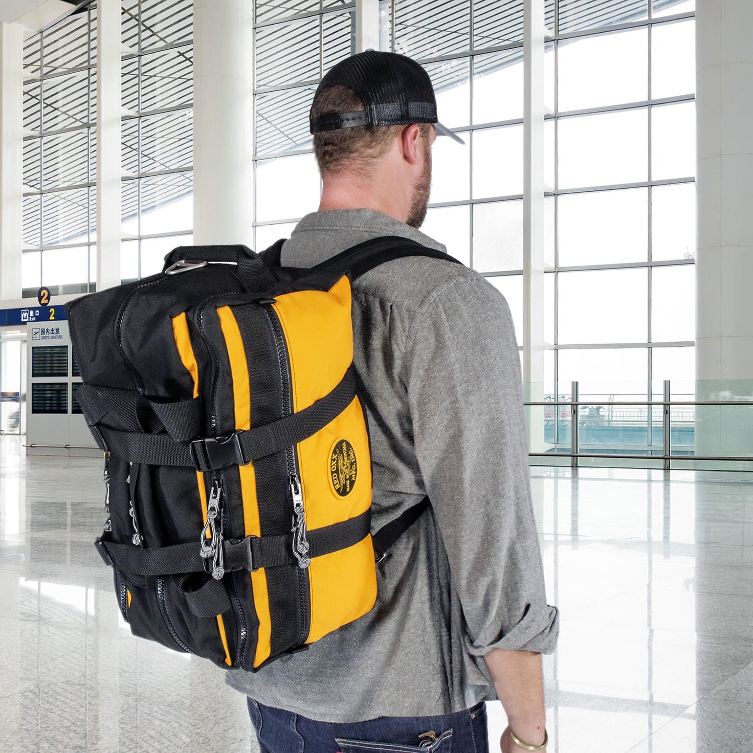 Lil Hombre in Airport with male traveler.