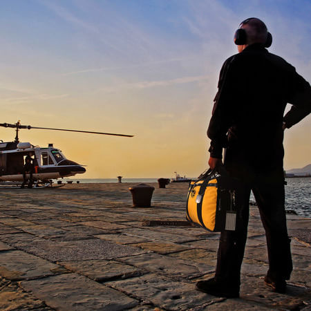 Man on air strip with Mini Boss and helicopter. 