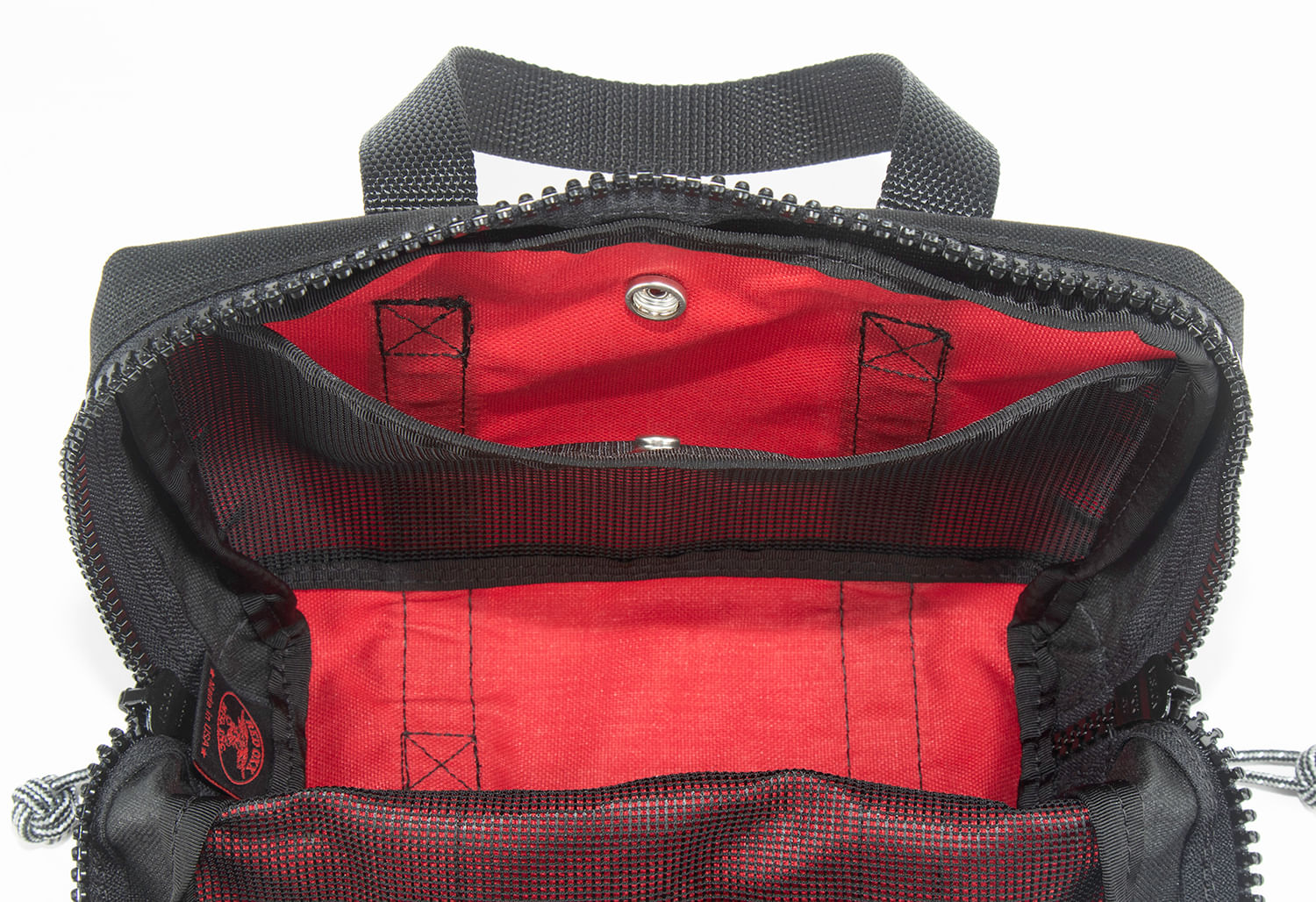 Internal view of the Lil Roy with mesh divider in the open position with snap closure.