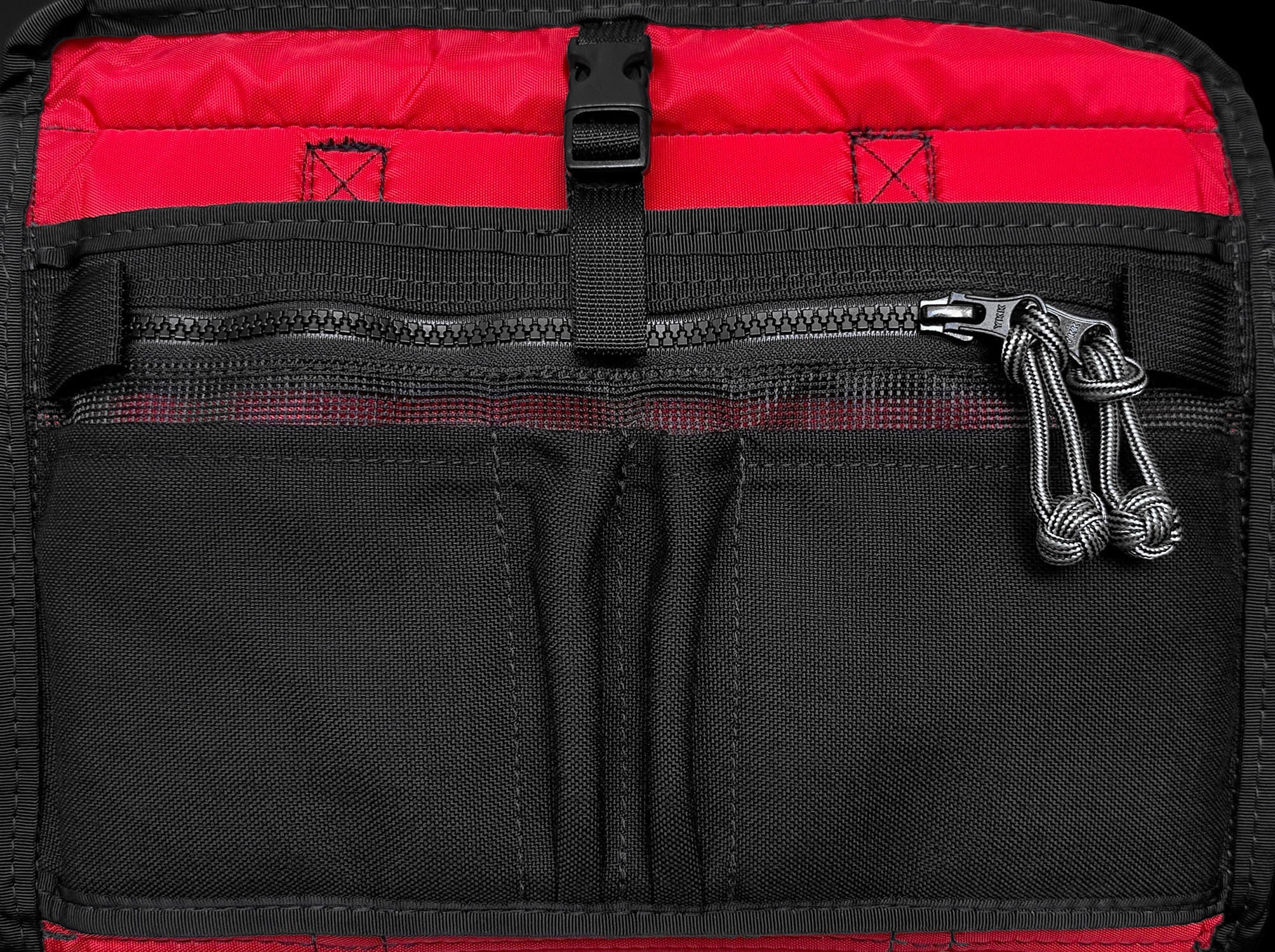 Interior features of the PUP. Two slip pockets and two pen and pencil holders with zippered mesh pocket. Fastex closure for tablet.
