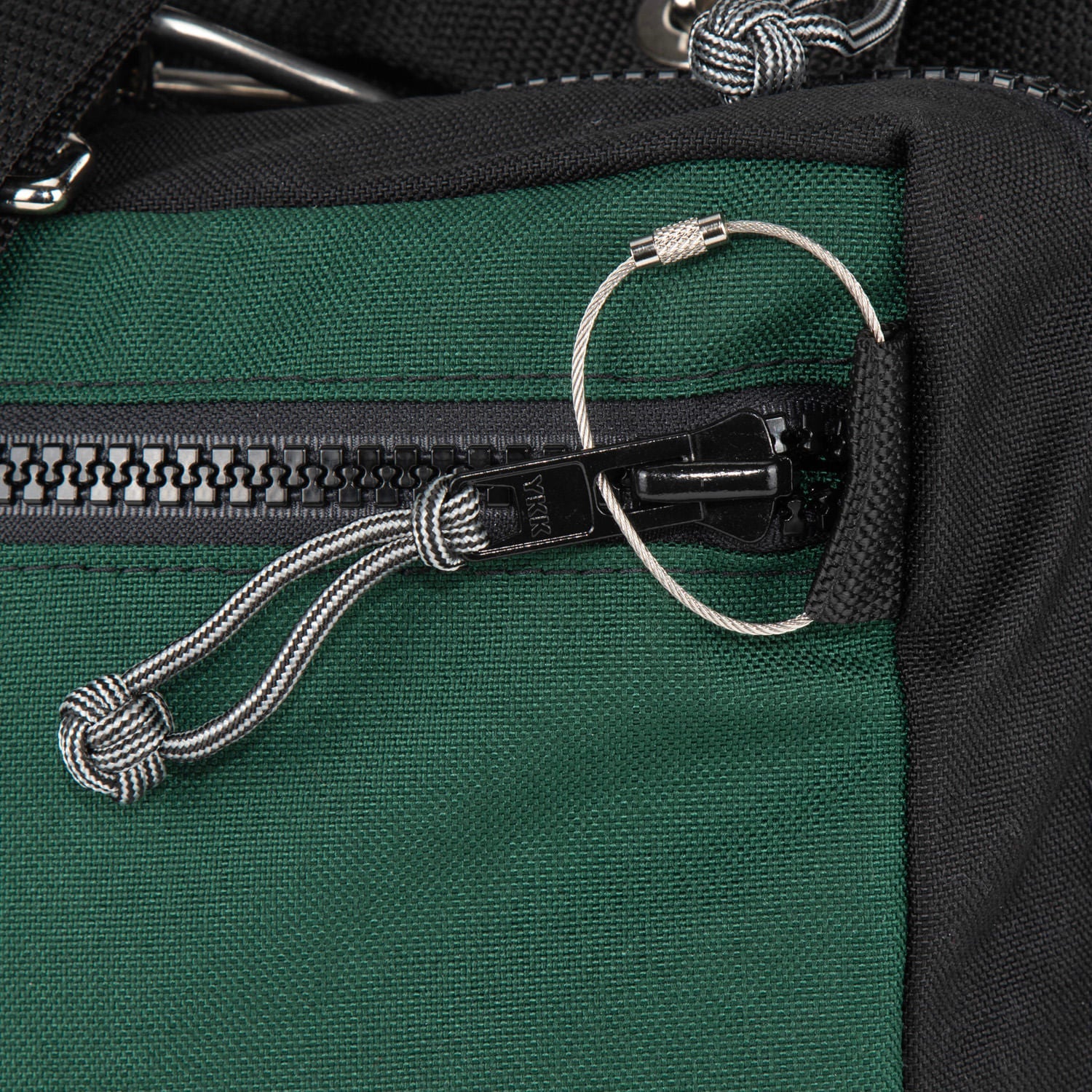 Lock your bag with a cable lock.  no keys no combination required. 