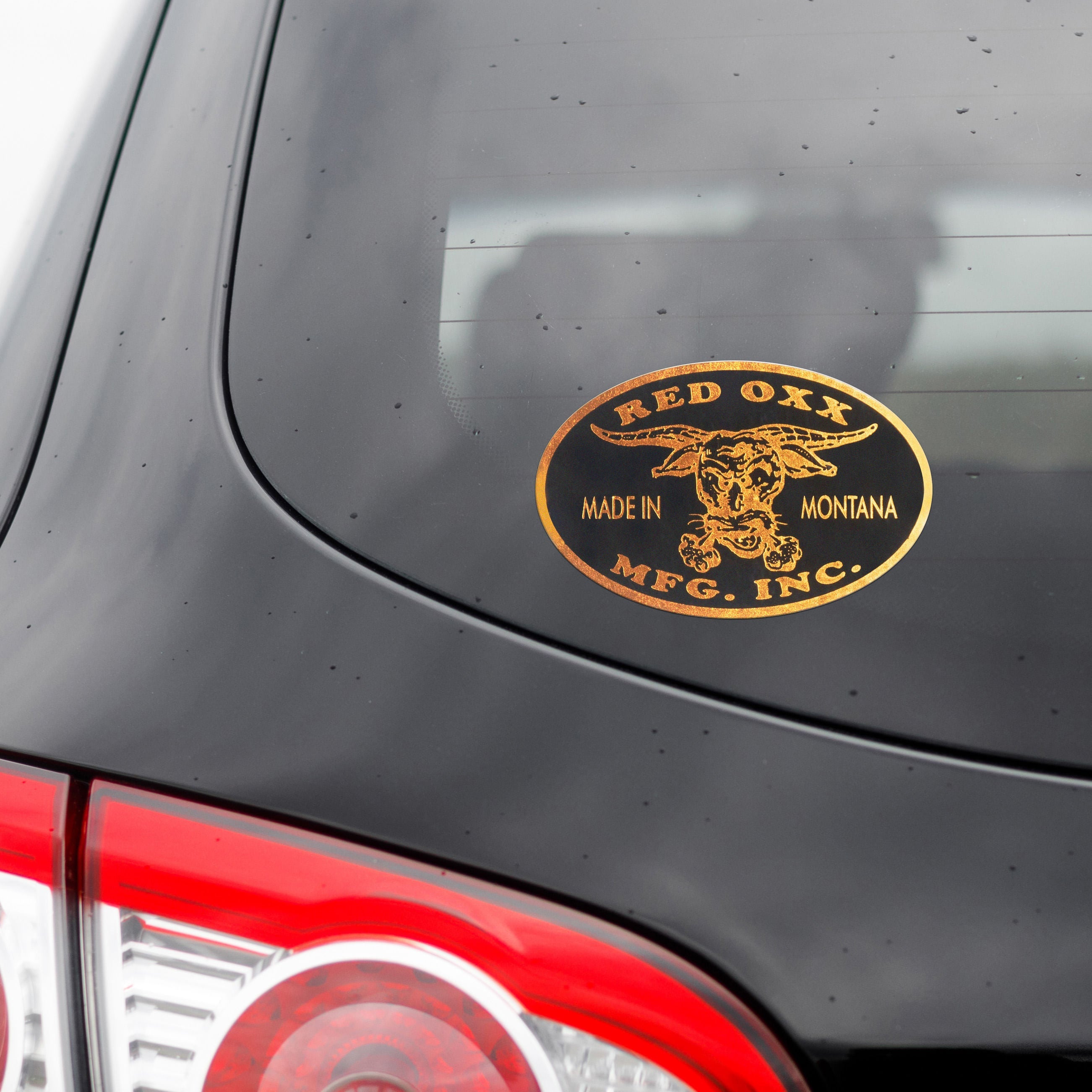 Bronze Red Oxx sticker on a vehicle. 