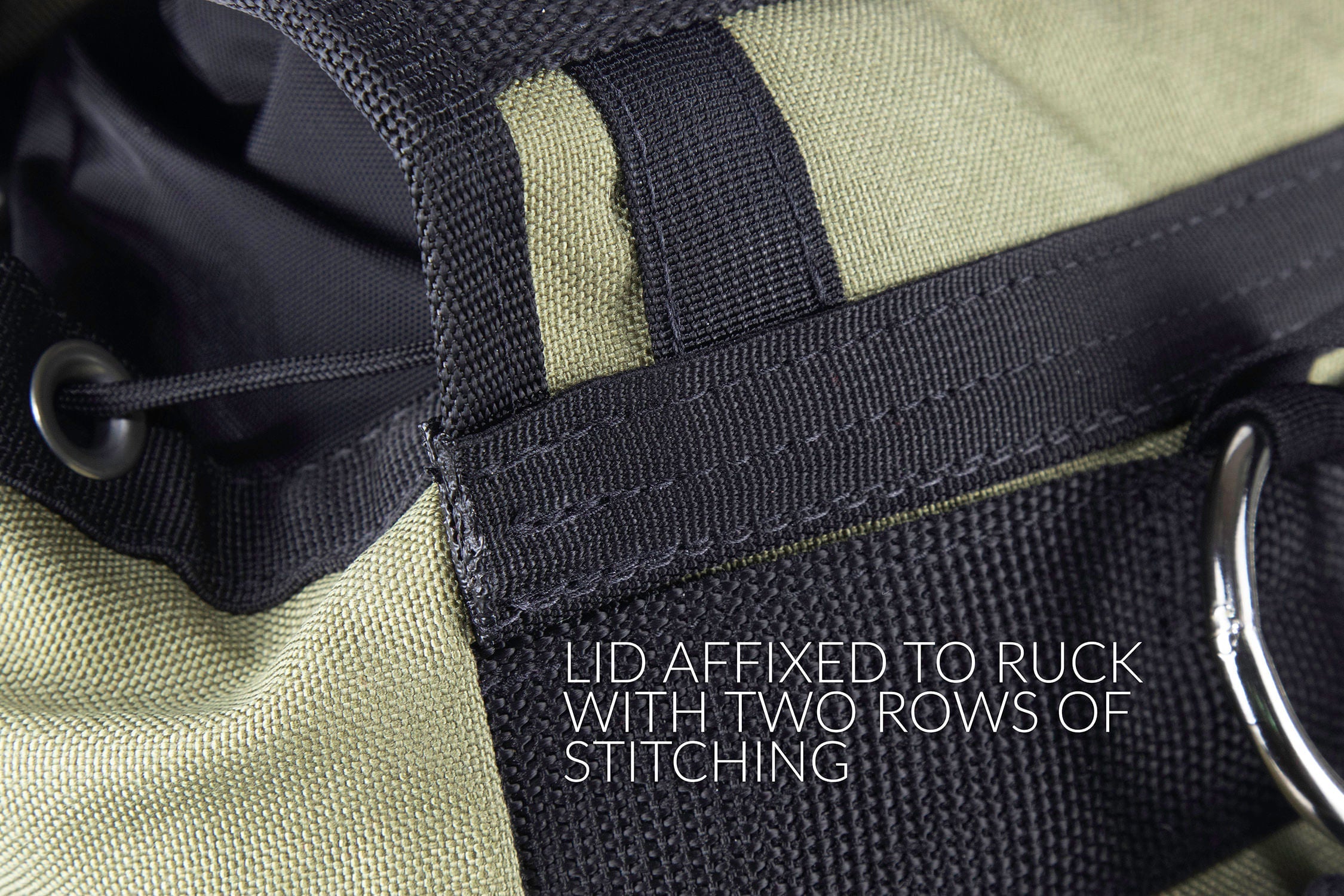 Detail of lid affixed to ruck with two rows of stitching.