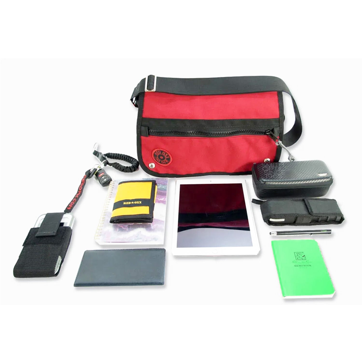 group picture of sample items that will fit into the messenger purse, Cell phone, wallet, I pad, sunglasses, notebook, key fob.
