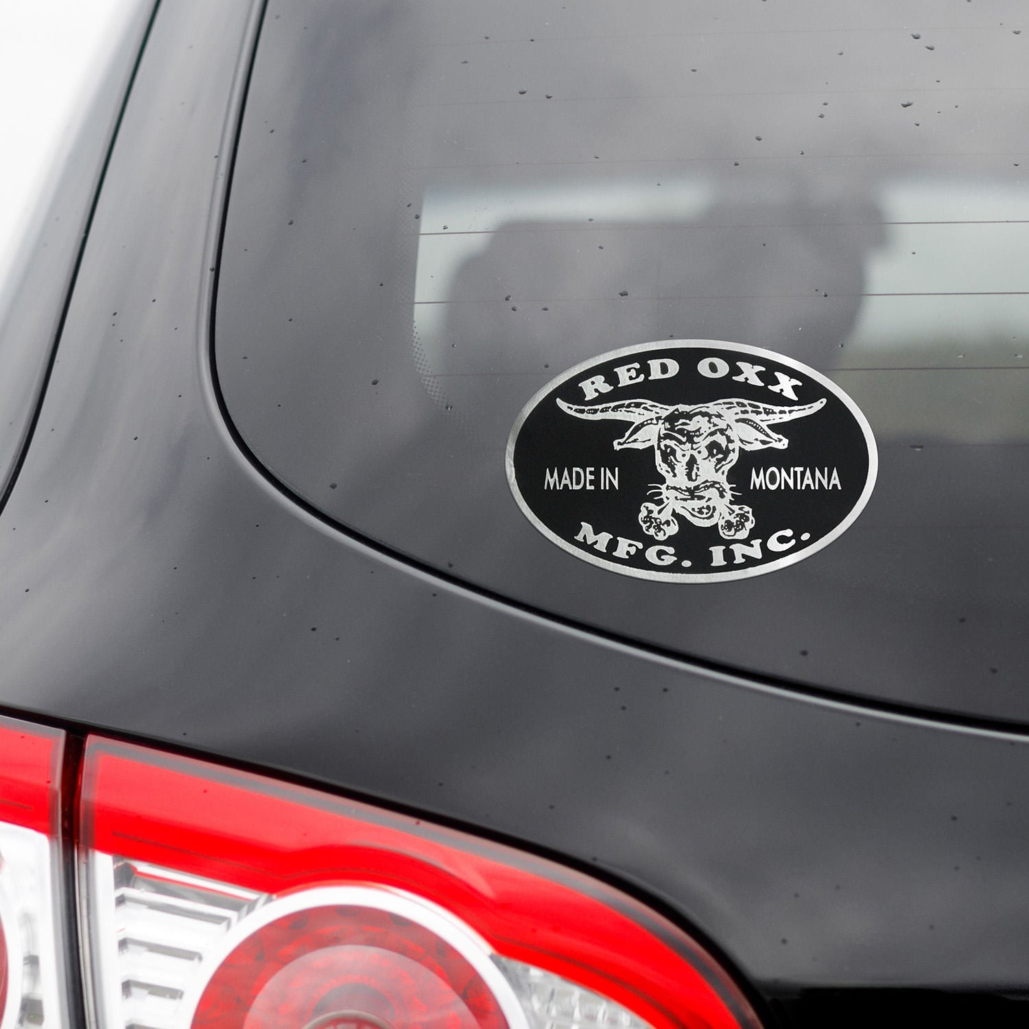 Silver Red Oxx sticker on a vehicle. 