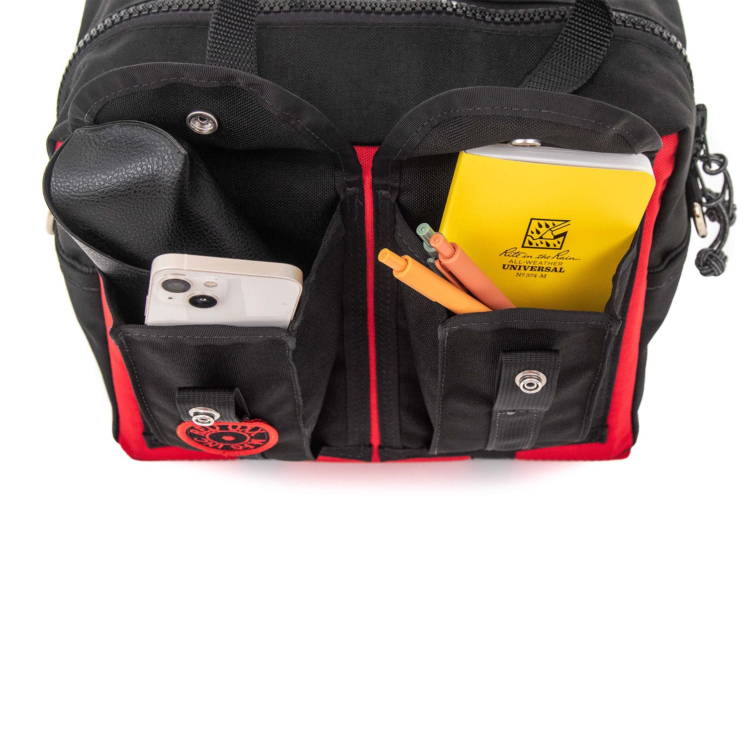 Expandable side pockets loaded with EDC gear. 
