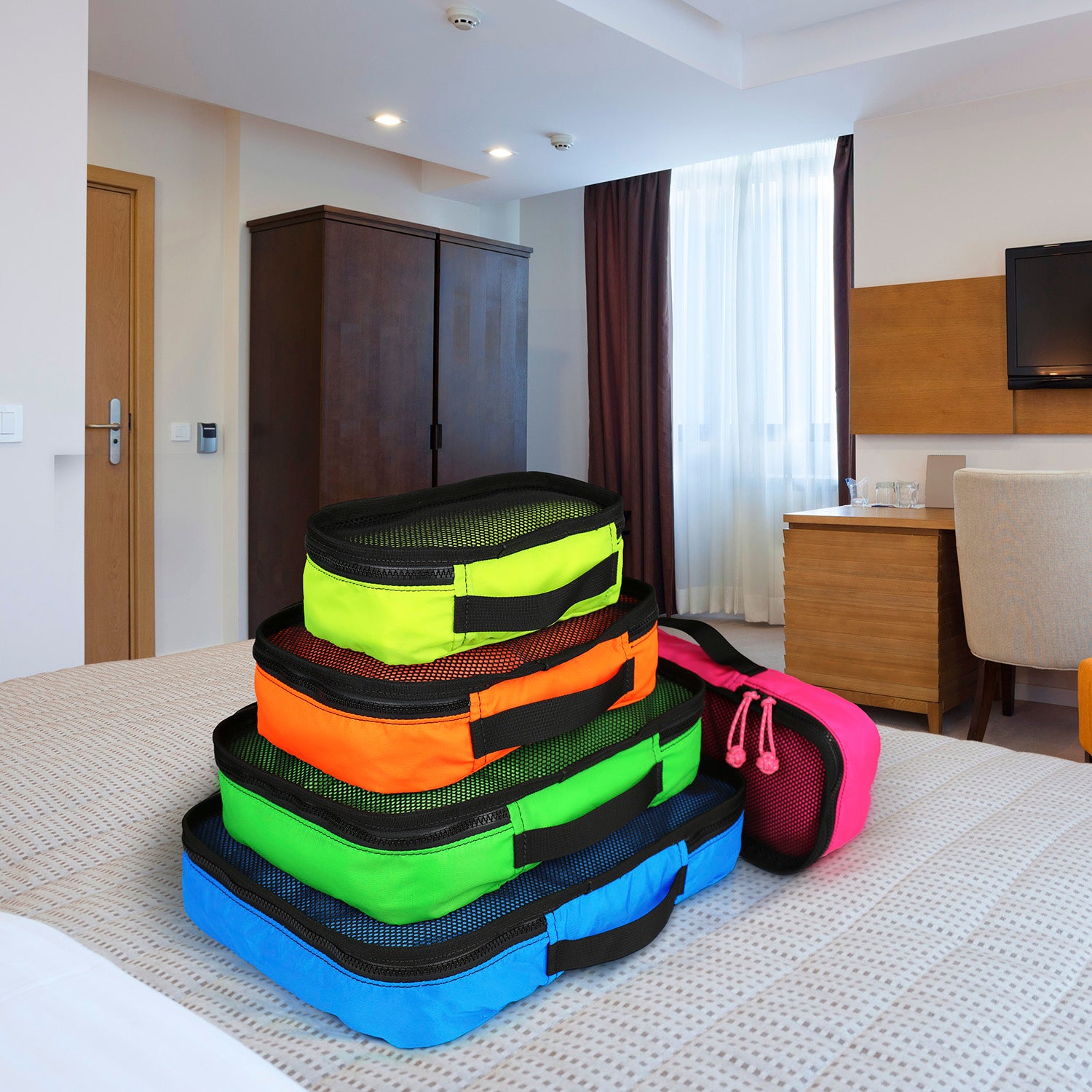 Stacked view of packing cubes in each color available. 