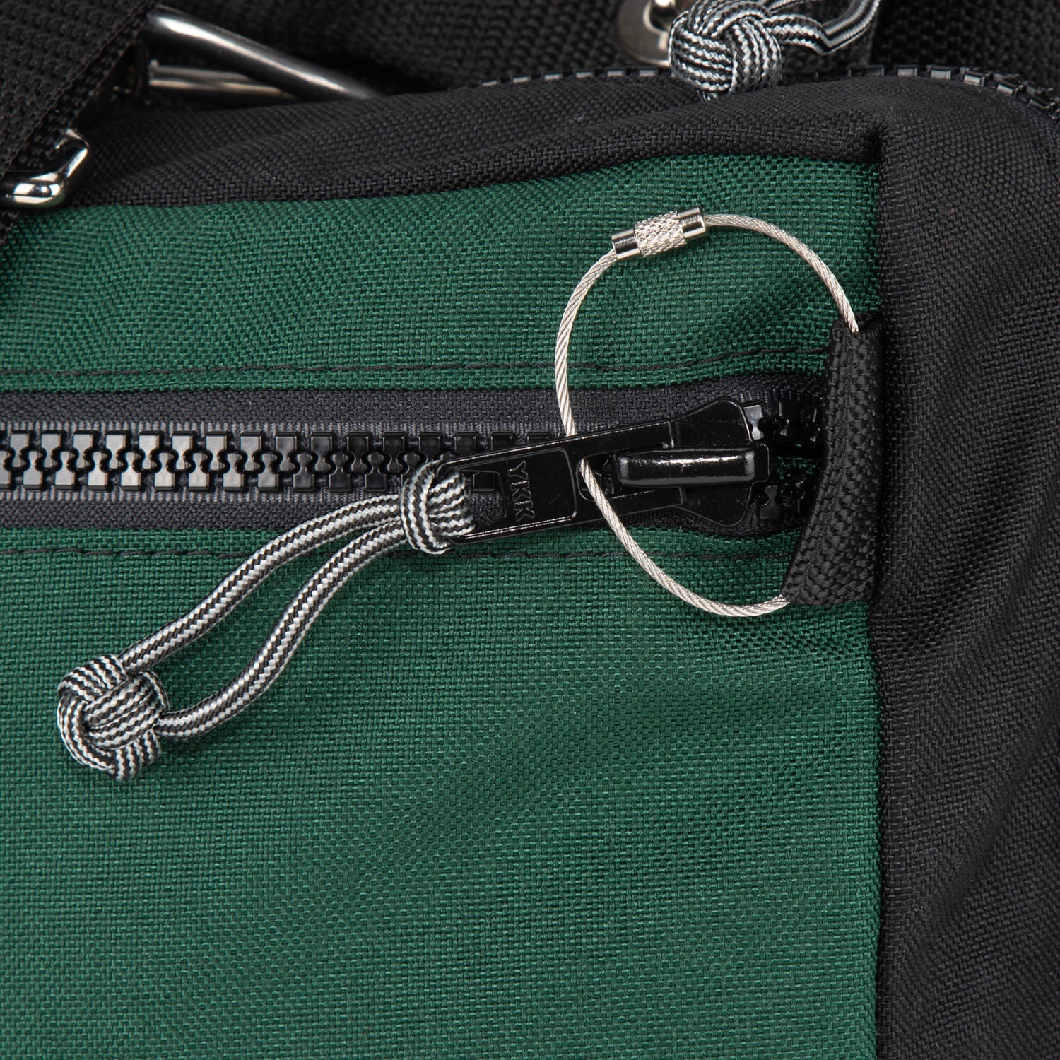 Lock your bag with a cable lock.  no keys no combination required. 