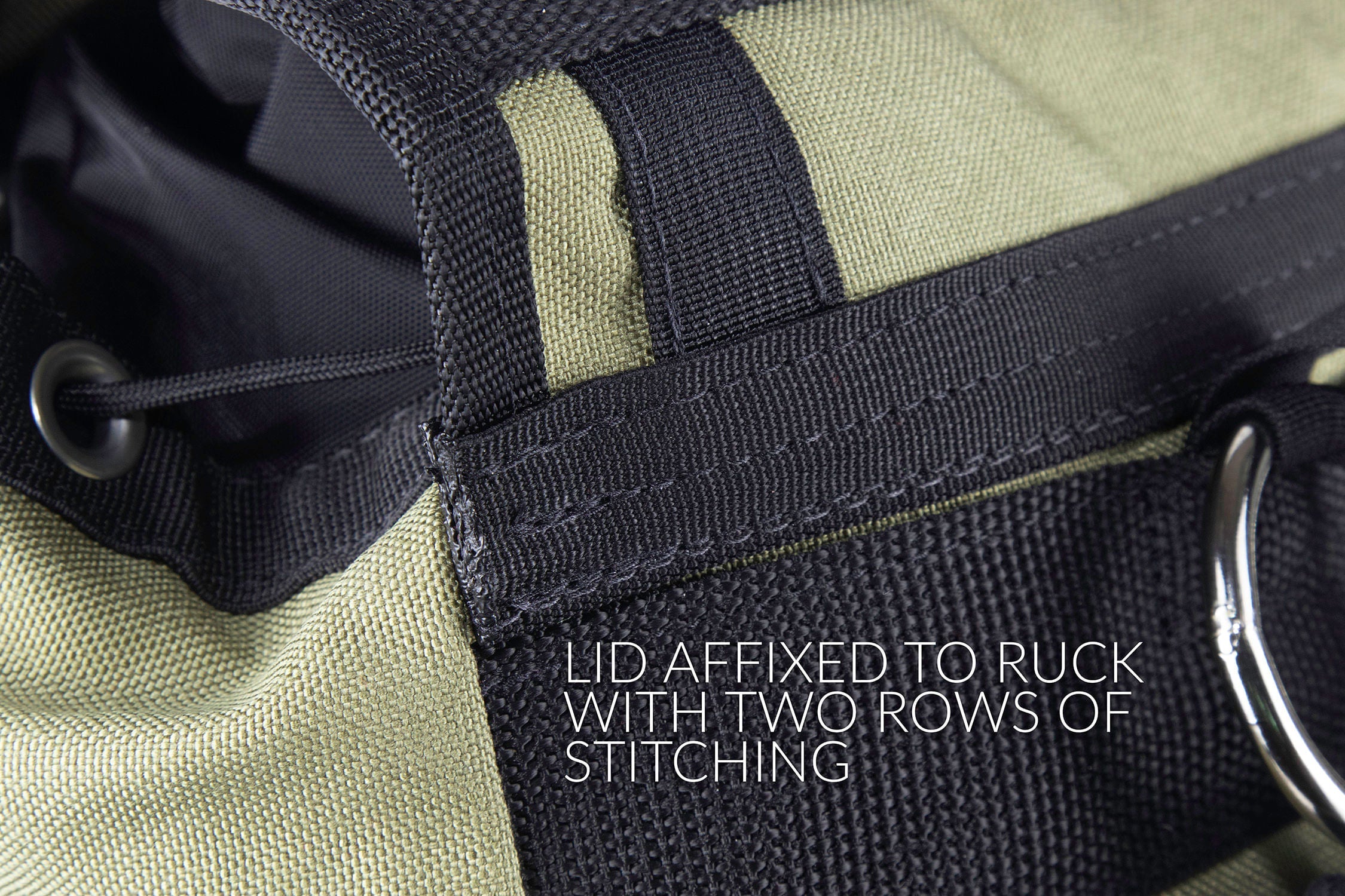 Detail of lid affixed to ruck with two rows of stitching. 